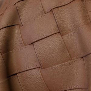 Brown woven leather on curved geometry.